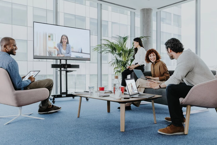 People in meeting area with screen
